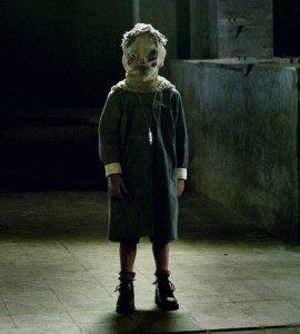 Masked children wander through the corridors of "The Orphanage."