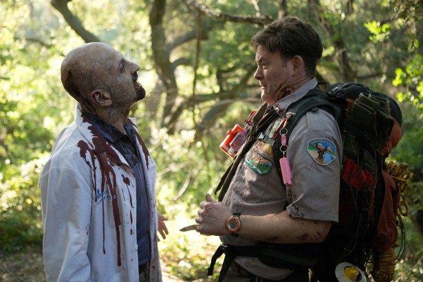 David Koechner who plays Scout Leader Rogers comes face-to-face with a zombie in SCOUTS GUIDE TO THE ZOMBIE APOCALYPSE from Paramount Pictures.